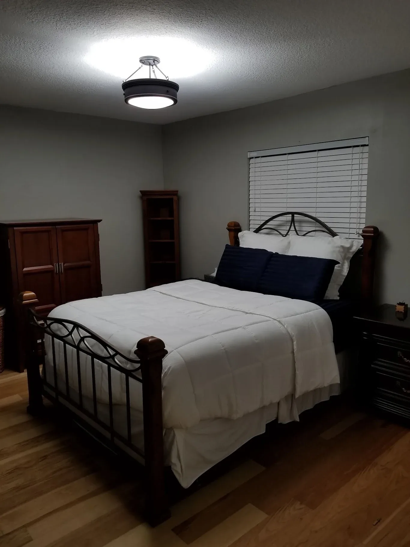 Updated bedroom ceiling light fixture during a rental unit turnover