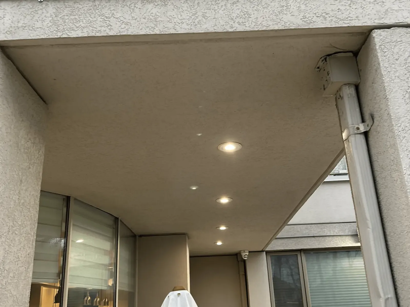 New soffit pot lights installed under an exterior overhang